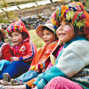 local kids in Peru on the best service trips for teens smiling while looking to the right