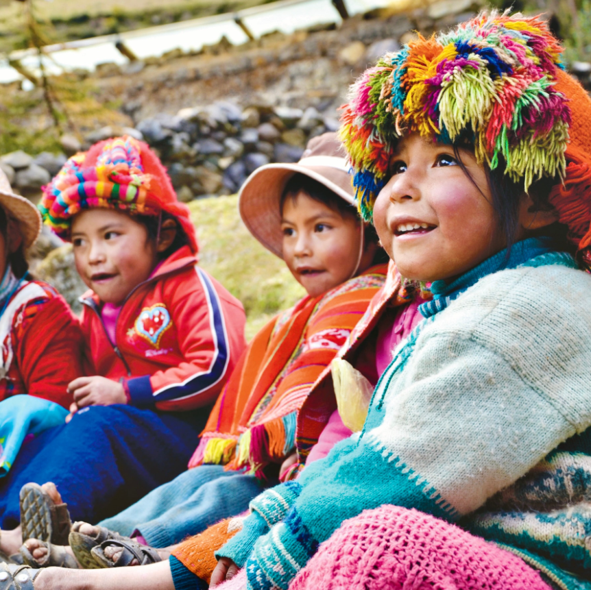 local kids in Peru on the best service trips for teens smiling while looking to the right