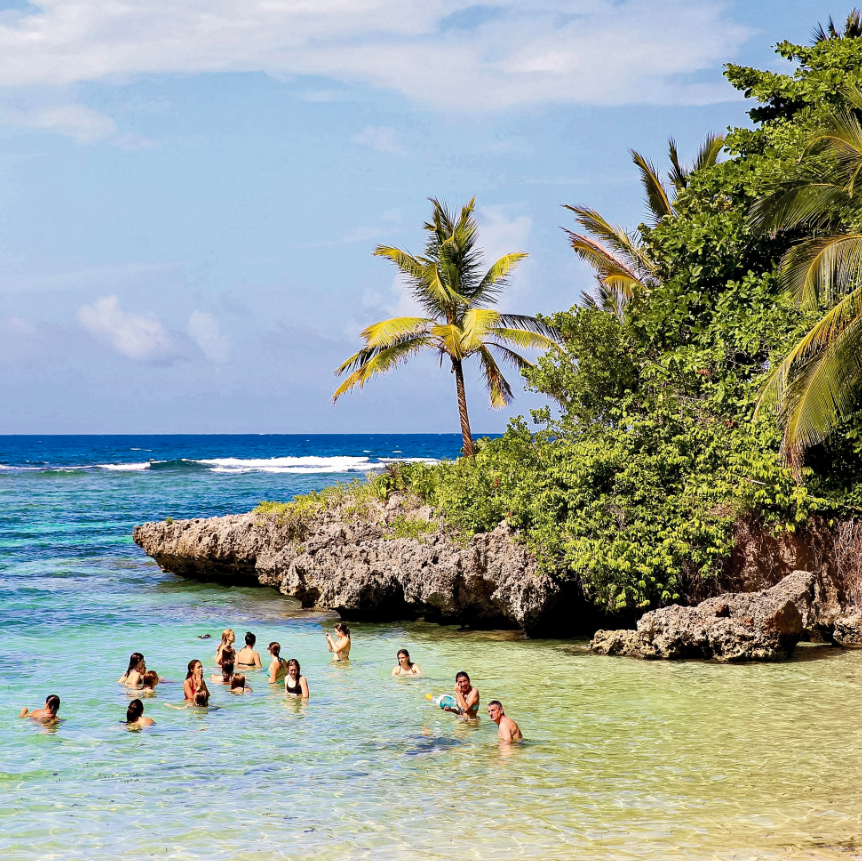 best service trips for teens rustic pathways swimming in the tropical water with the green nature on the mountain beside them and palm trees