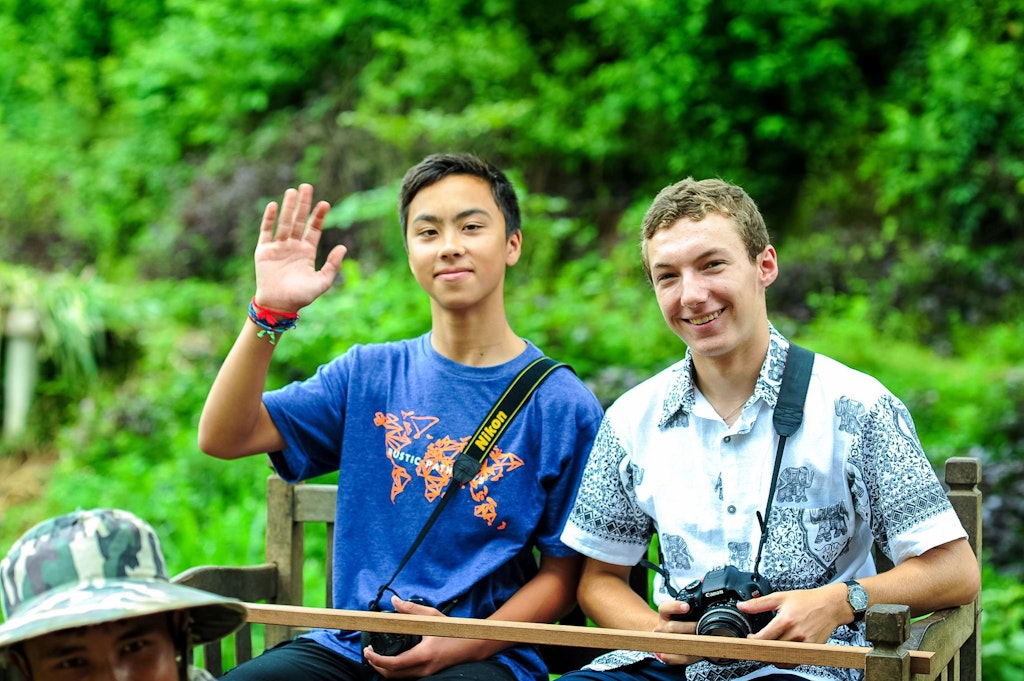 Students taking photos and learning about culture during a childcare volunteering abroad trip.