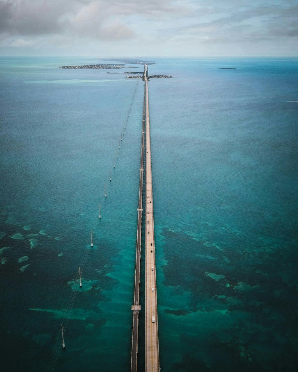 Picture of seven mile bridge in Florida Keys. Bridge in the middle and ocean to the left and right.
