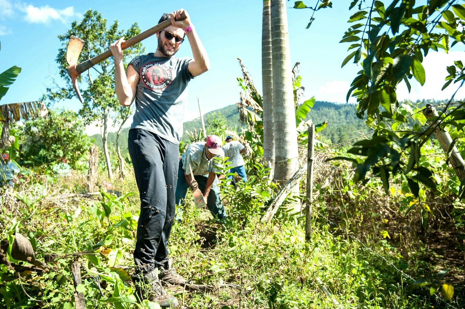 Gap year participant learning sustainable agriculture through hands-on garden work.