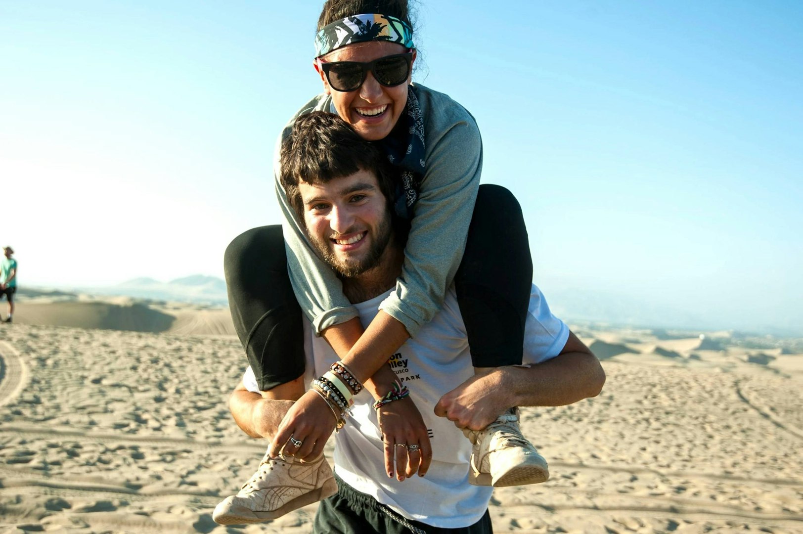 Gap year friends sharing a fun moment in the desert.