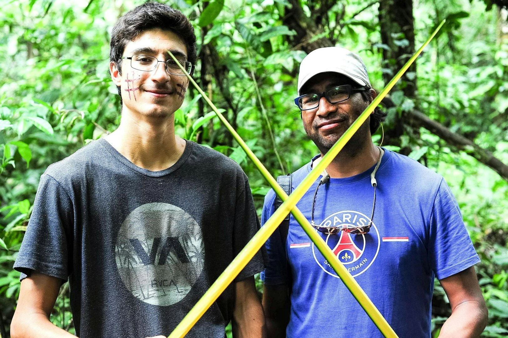 Two gap year participants learning from local community members during cultural immersion.