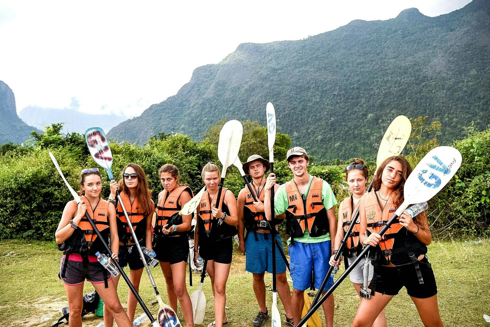 Gap year vs college: students preparing for a group kayaking adventure during their gap year.