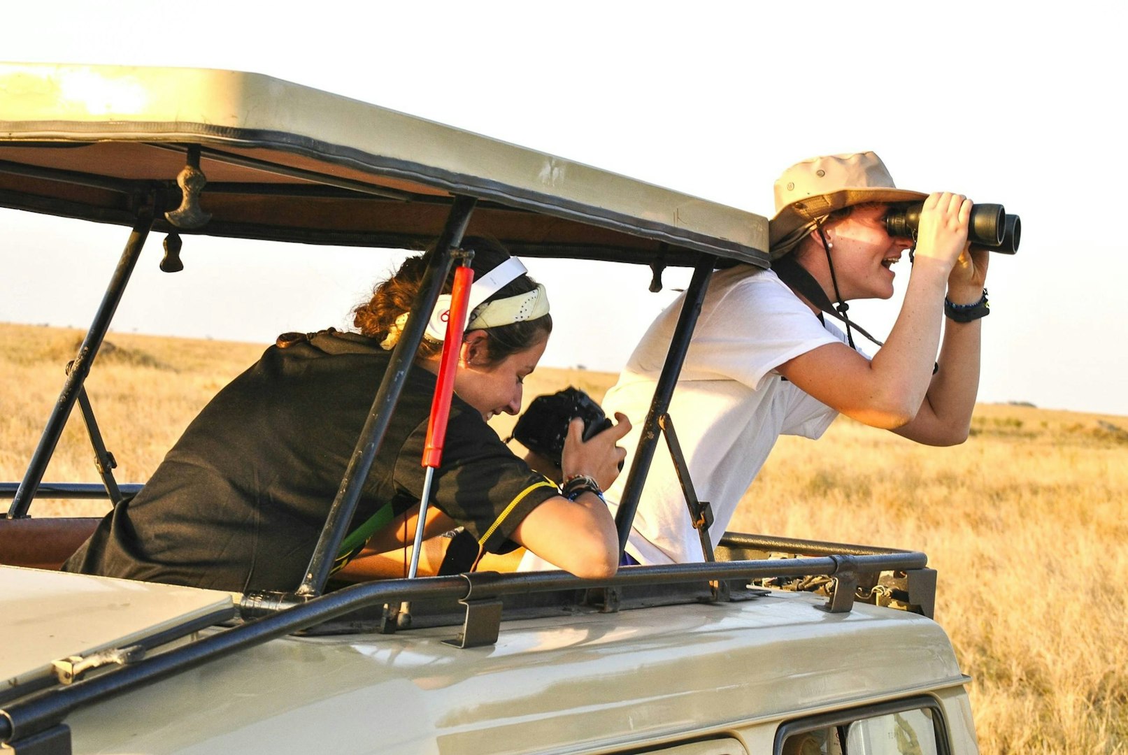 Gap year students on safari photographing wildlife in Africa.
