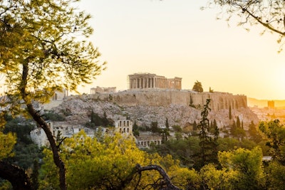 The Parthenon bathed in golden light at sunset.