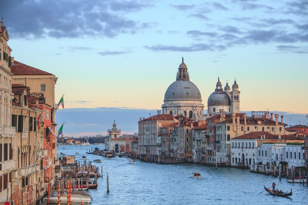 Explore the Grand Canal in Venice – one of the best things to do in Italy at sunset.