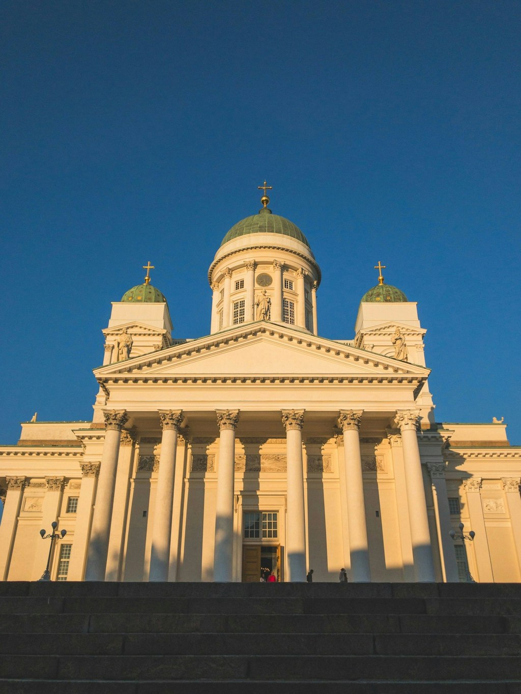 White Helsinki Cathedral in front of the blue sky.