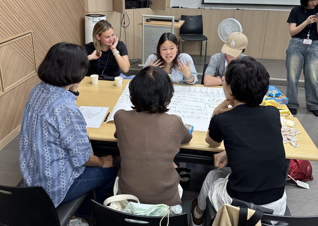 A group of travelers taking a beginner Korean lesson during a language immersion teen tour in South Korea.