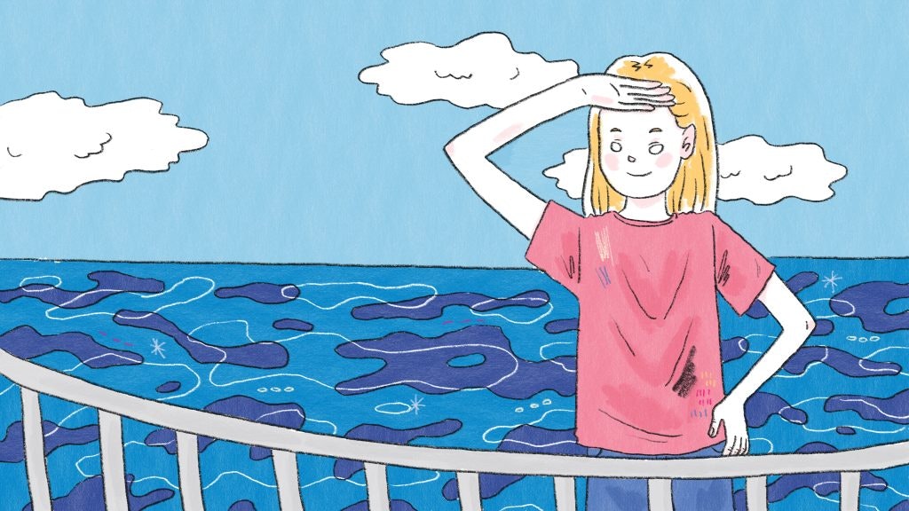 A student staring out over a sparkling blue ocean, motivated to create lasting change.