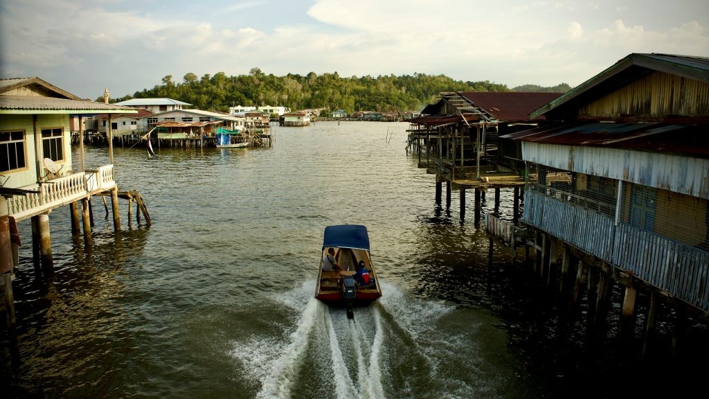 Boat navigating through water village houses
