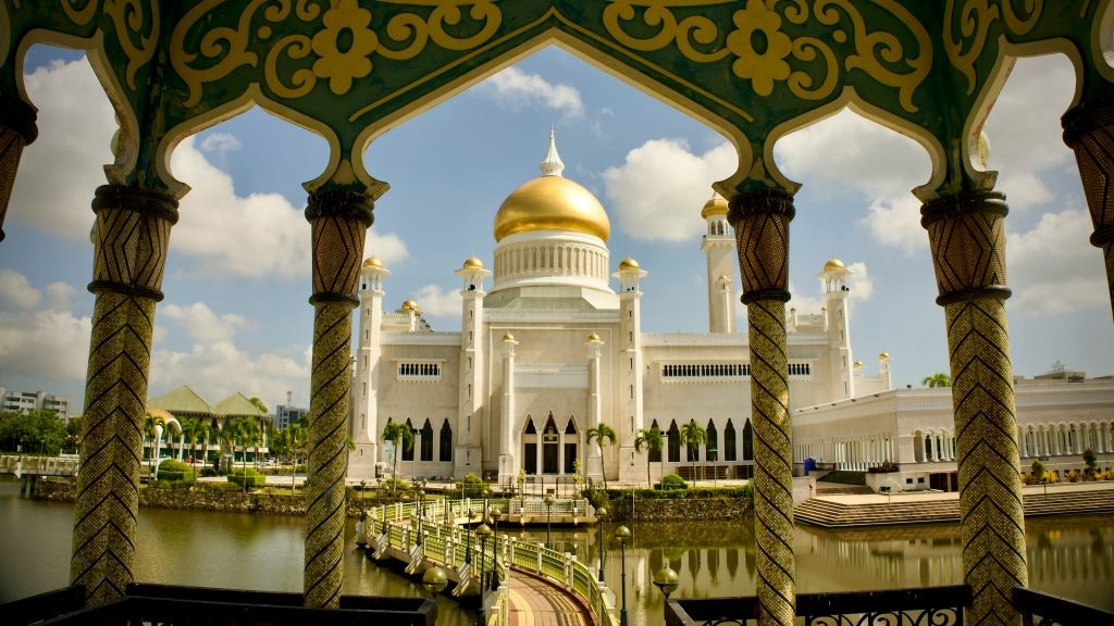 Beautiful mosque with golden domes framed by arches