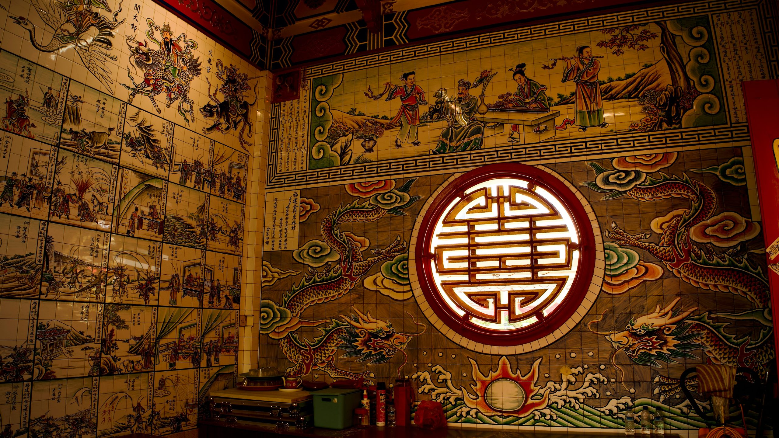 Intricate Chinese mural with dragon and traditional scenes