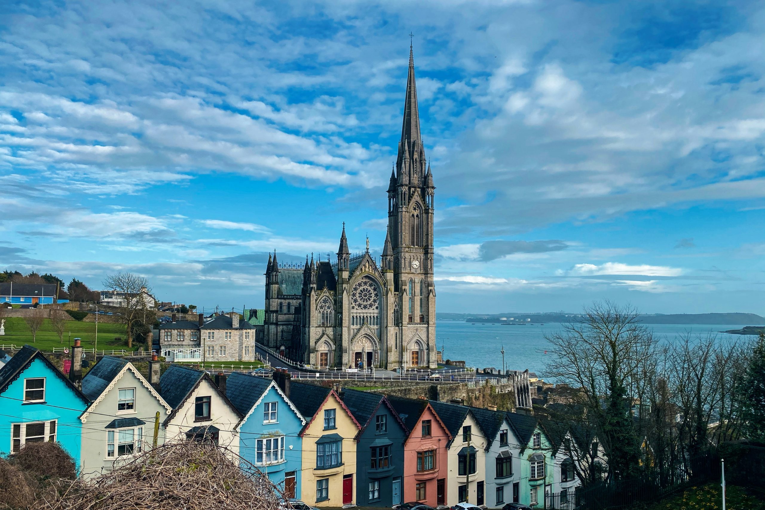 Picture of village with houses in the front and large building in the back in Cobh, County Cork, Ireland.
