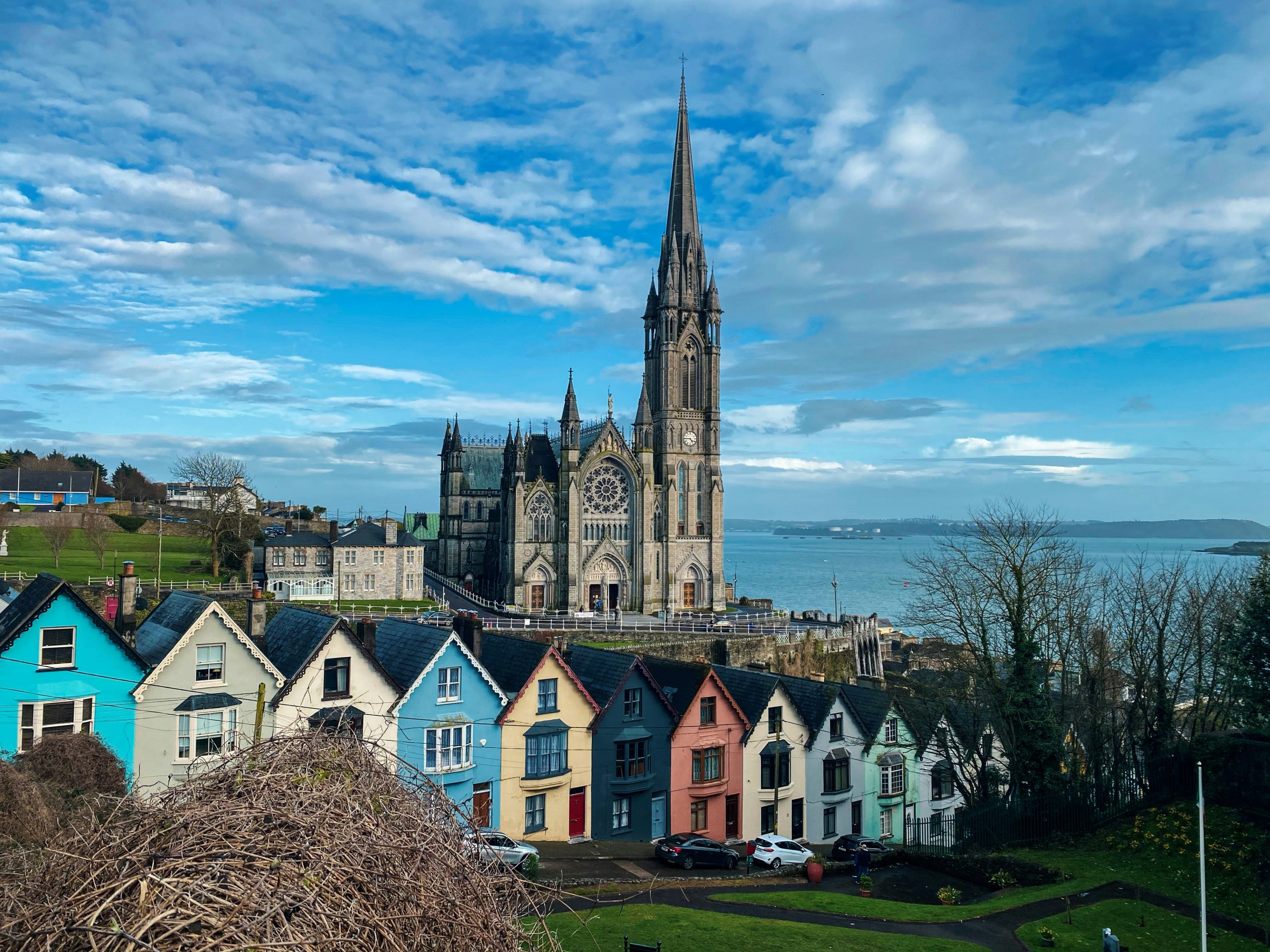Picture of village with houses in the front and large building in the back in Cobh, County Cork, Ireland.