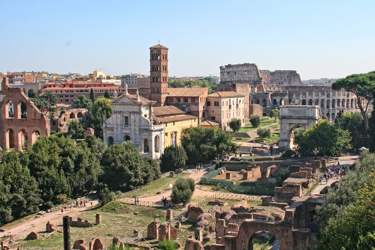 View over the Roman Forum with the Colosseum and city rooftops in the distance