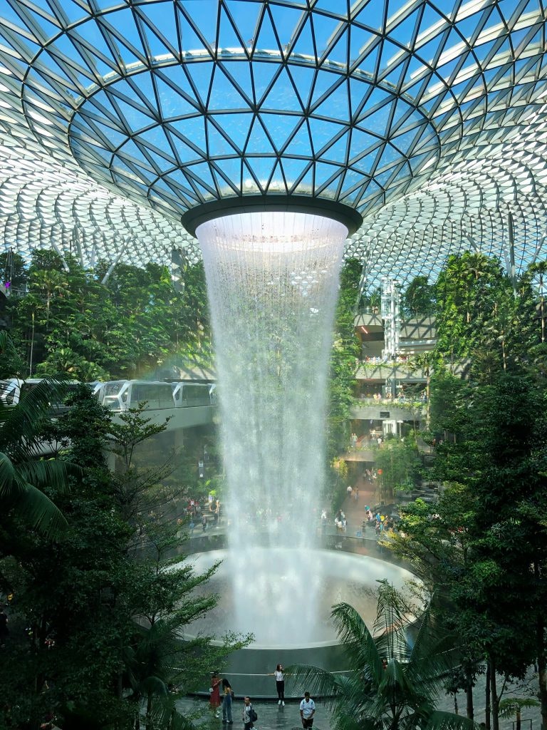 The Jewel Rain Vortex in Singapore with water cascading down from the veiling in a circle.