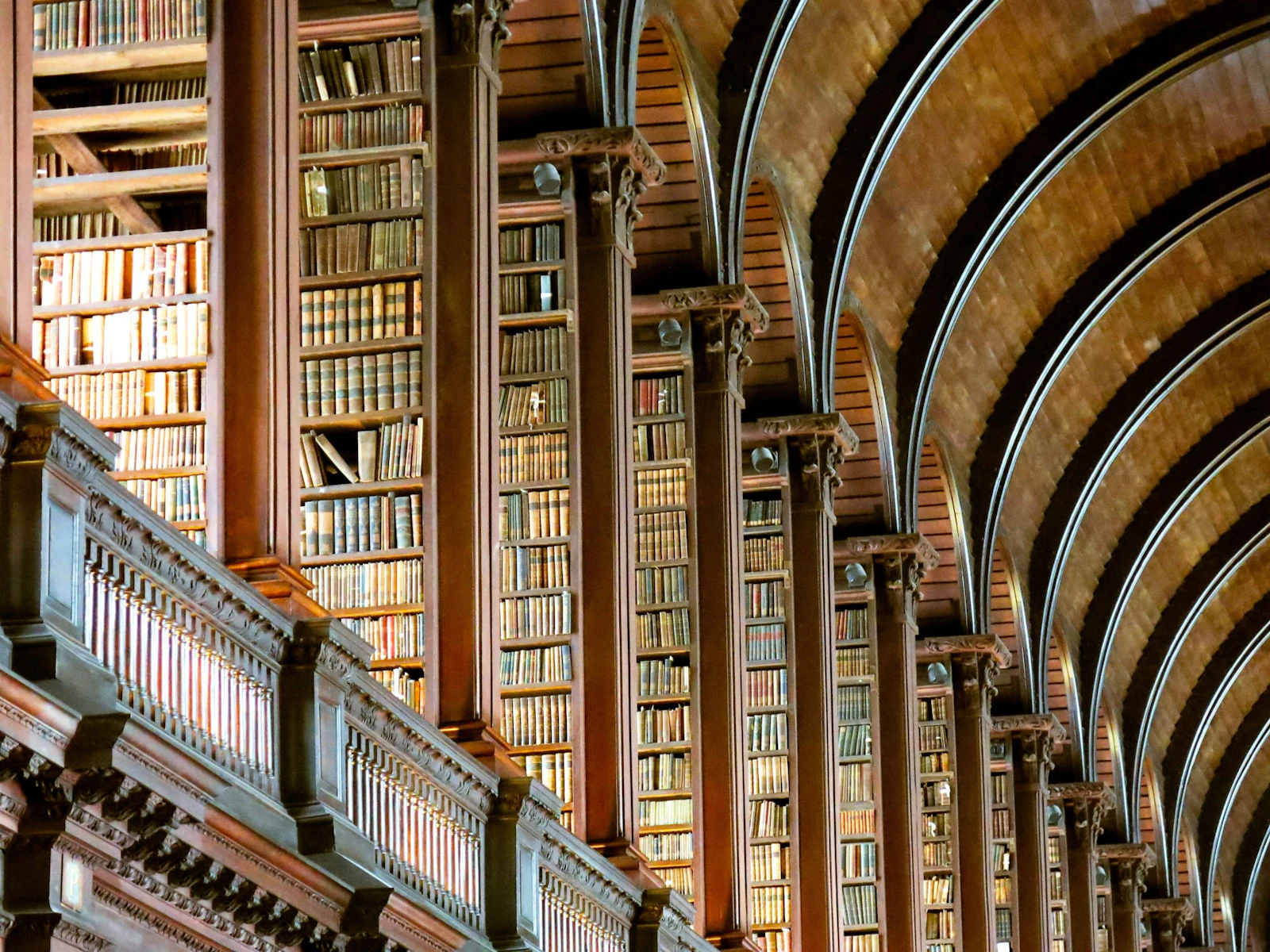 Two storeys of dark wooden bookcases line the barrel-vaulted Long Room library at Trinity College Dublin