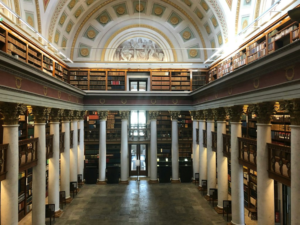 Inside the main room of the National Library of Finland showcasing unique architecture features.