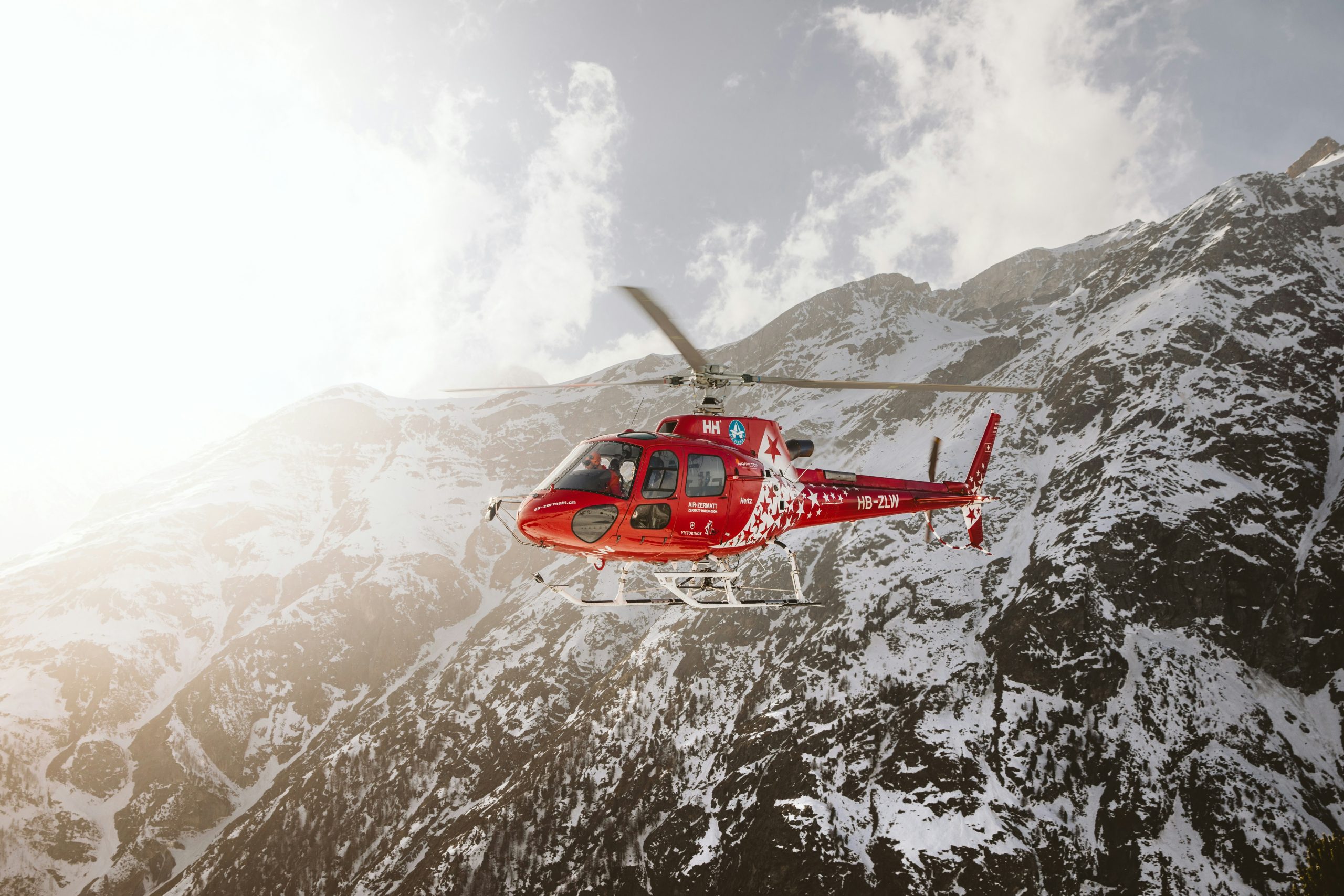 Search and rescue helicopter in the snowy mountains.