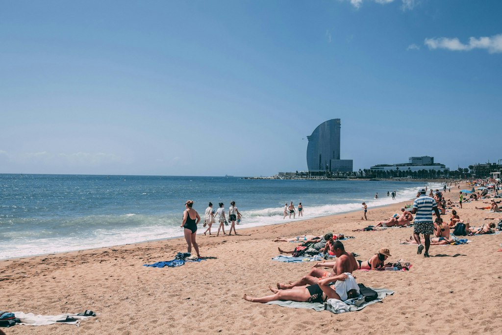 People relax on the beach in Barcelona. Learn more fun facts about Barcelona.