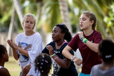 Student travelers participate in a cultural dance during a Dominican Republic teen tour