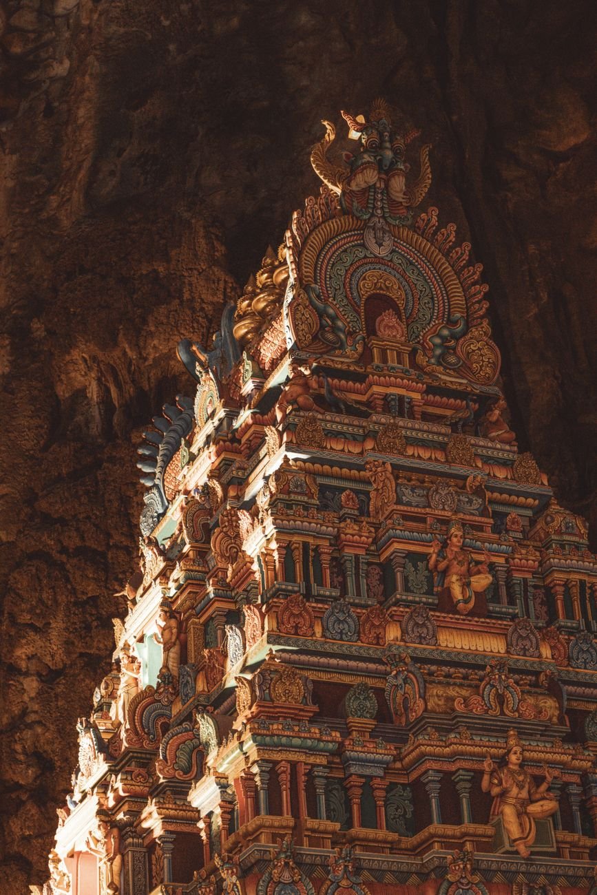 A small chapel built into a cave chamber, lit from above.