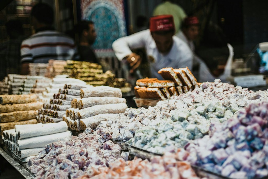 A market stall sells Turkish delight and other desserts.