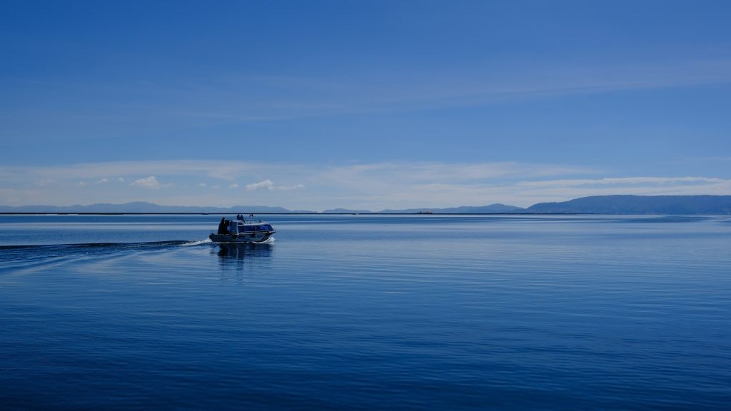 Fun facts about Bolivia. Lake Titicaca in Bolivia with a boat driving across the blue water