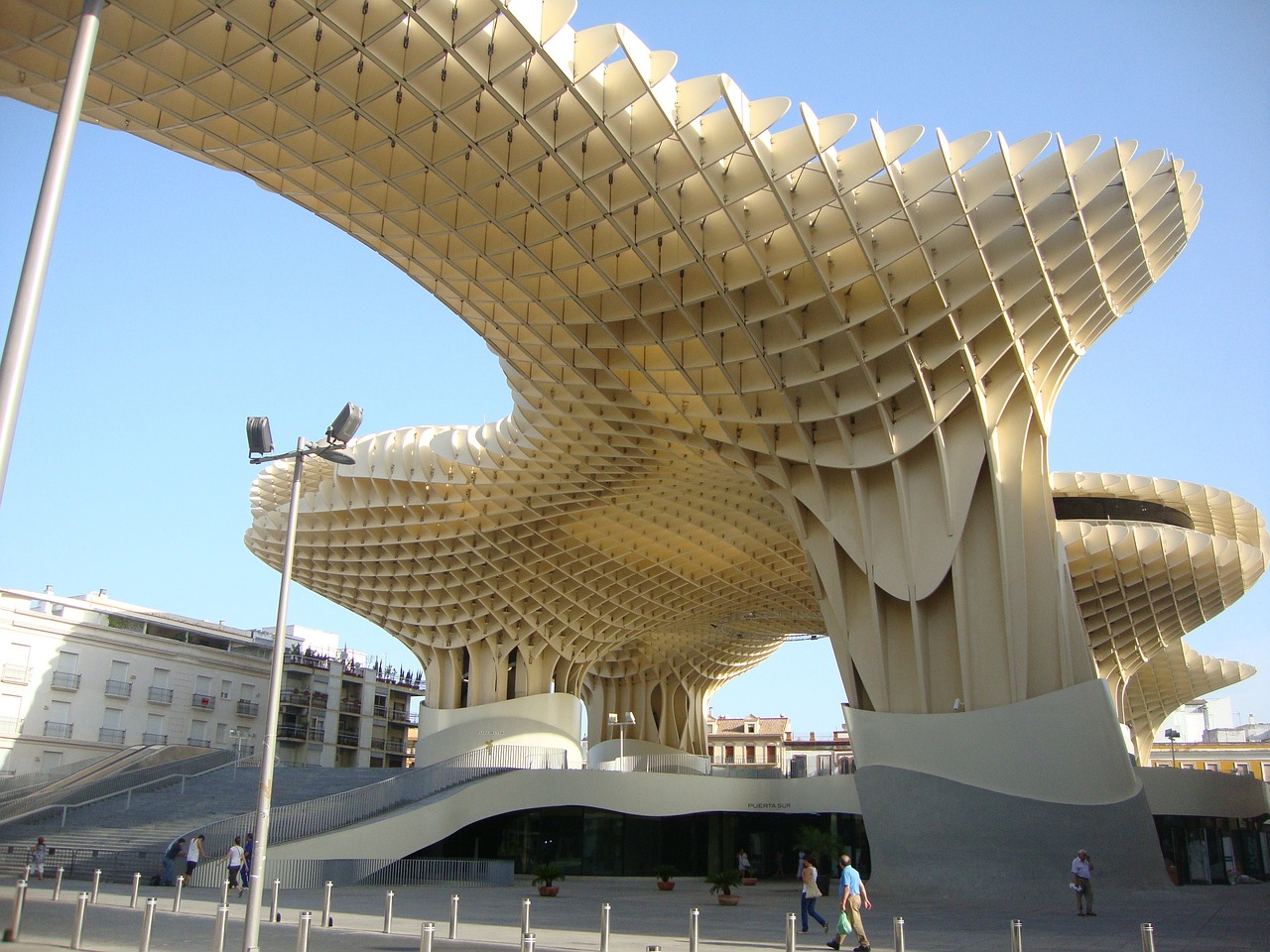 Wavy wooden lattice canopy of Metropol Parasol rises over a plaza in Seville