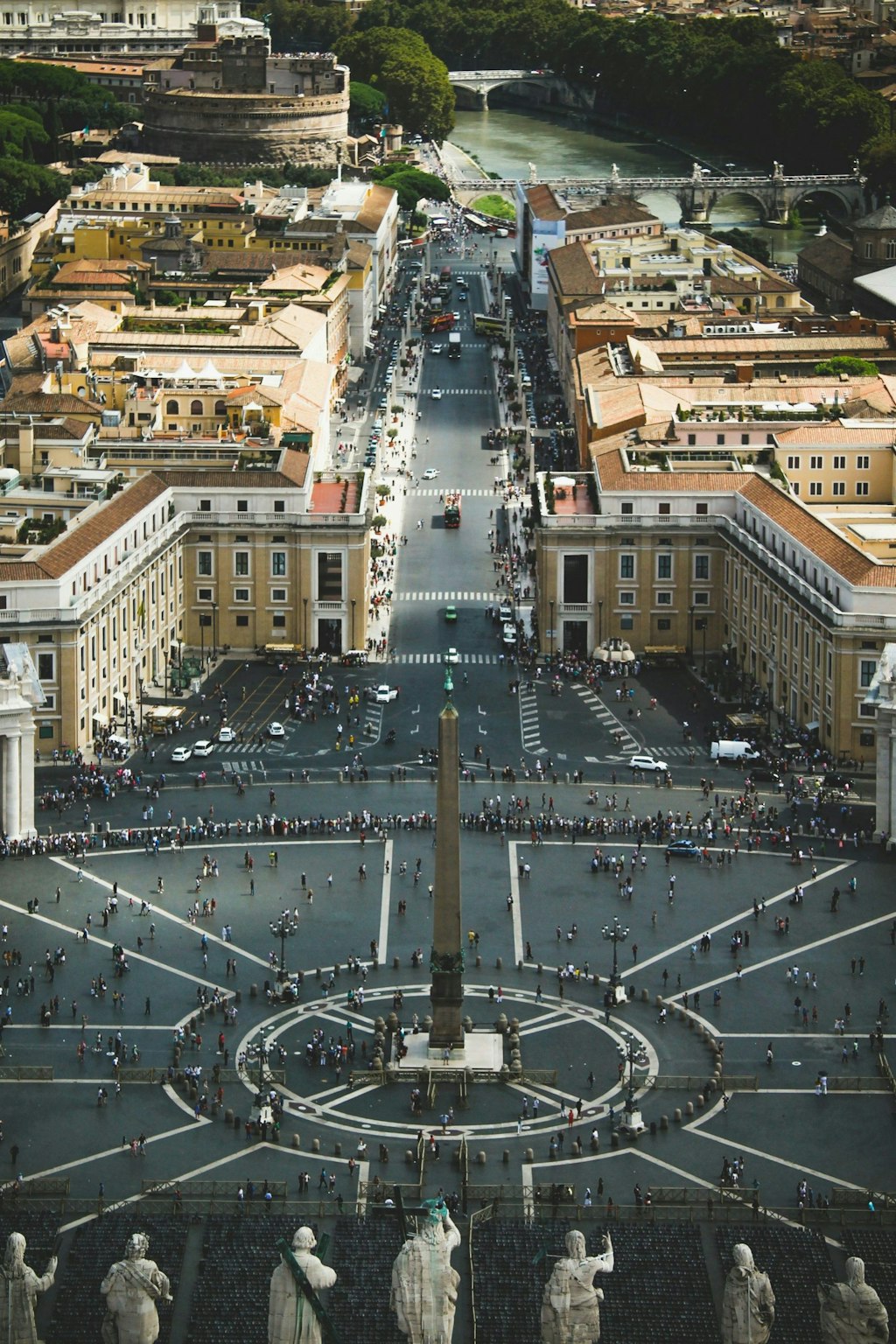 Picture shows St. Peter’s Square in Vatican City from above. It captures the architecture and visitors of the place. Fun facts about Rome is that Vatican City lays within Rome.
