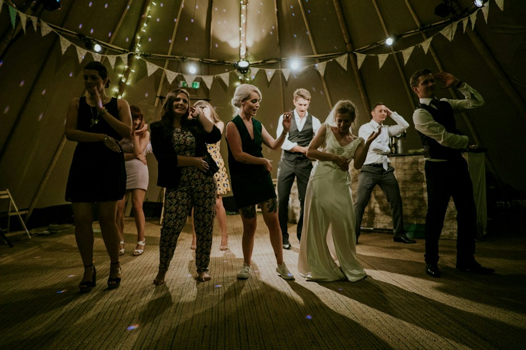 A bride shares a dance with a wedding guest.