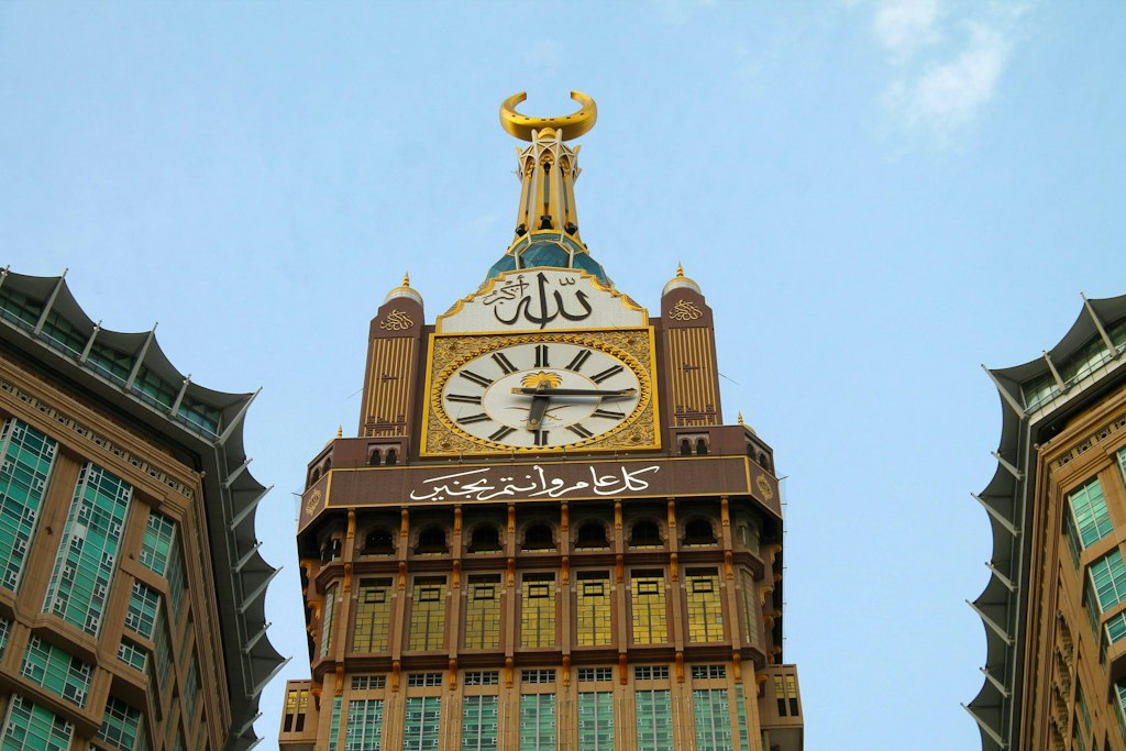 A view of the Makkah royal clock tower against the blue sky.