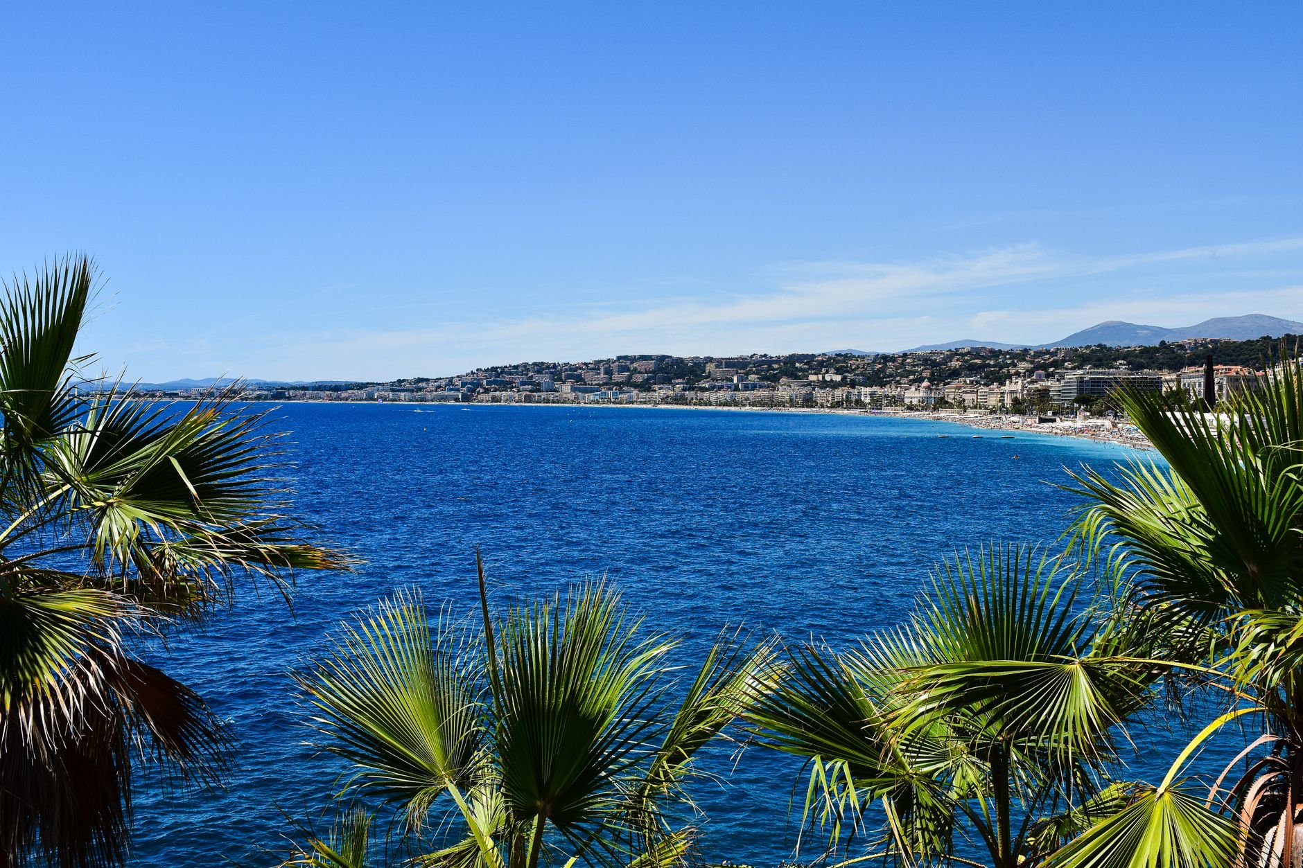 A coastline of hillside buildings above the sea under a clear sky.