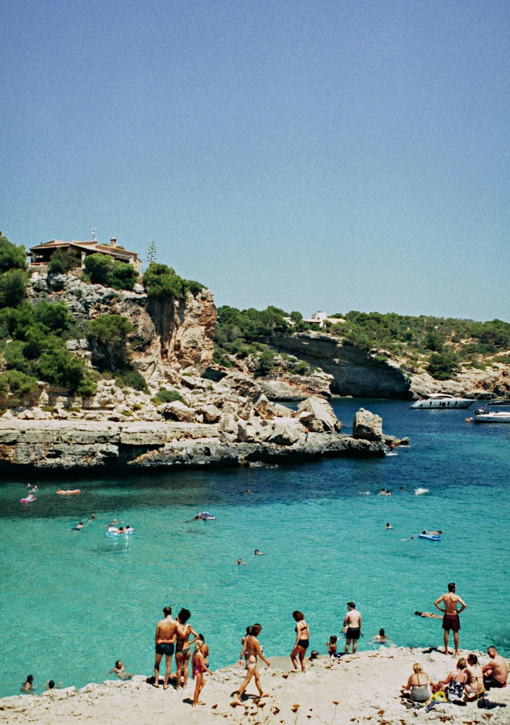Swimmers enjoying crystal-clear waters, surrounded by Mallorca’s rugged rocky landscape. Fun Facts About Palma de Mallorca