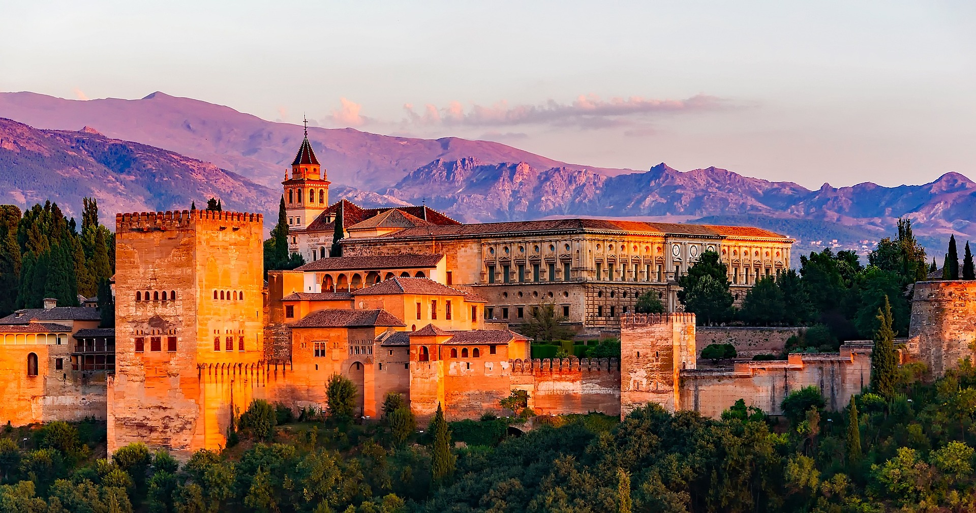 A school trip to Spain visits the Alhambra palace complex, which glows at sunset with mountains behind