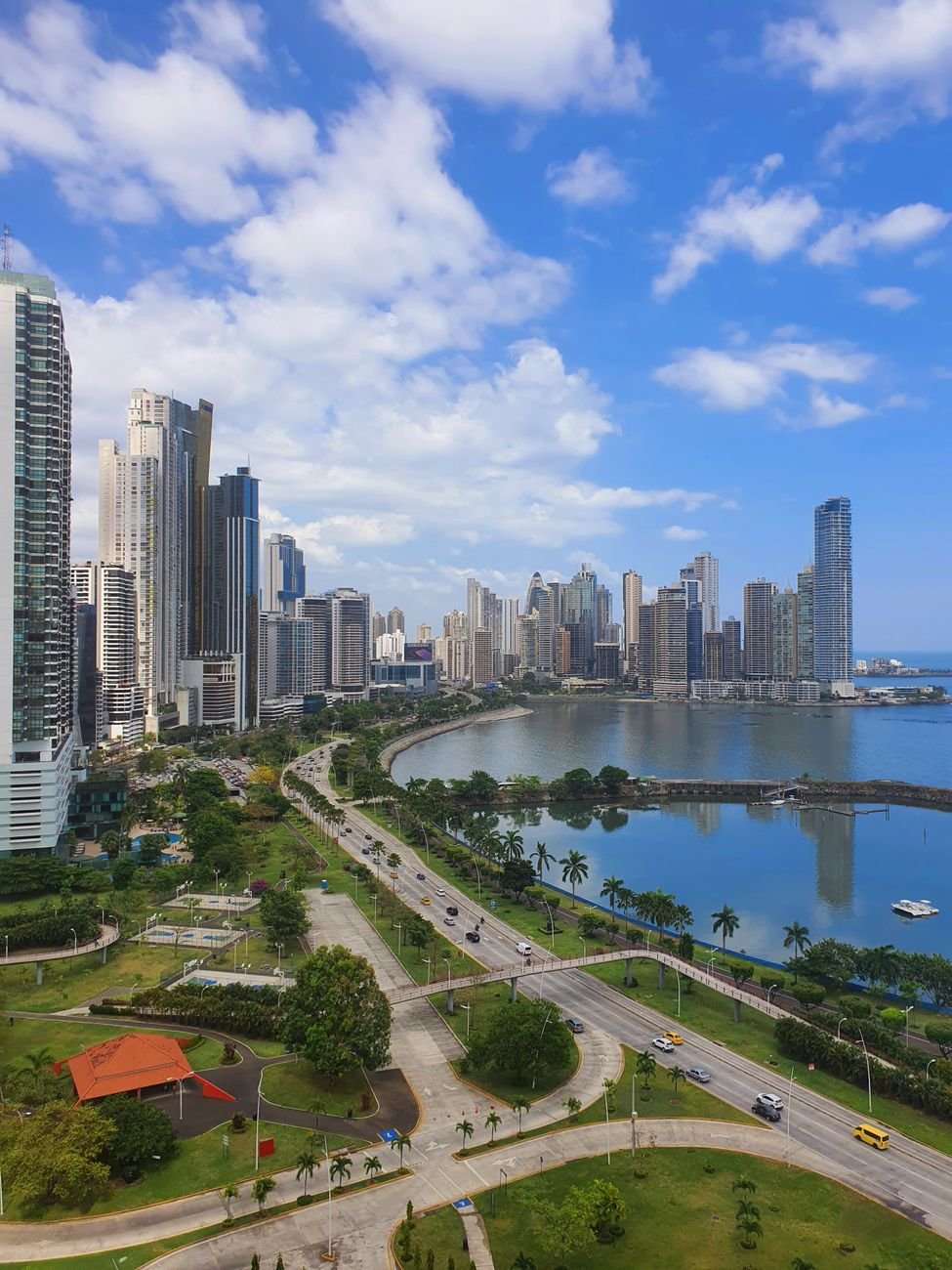 Modern skyscrapers along the waterfront skyline of a coastal capital.