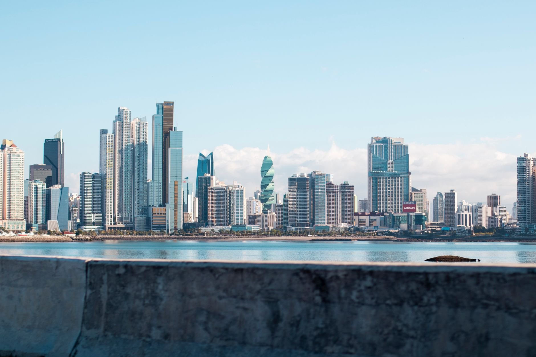 A coastline and skyline viewed from the sea, with high-rise towers along the shore.