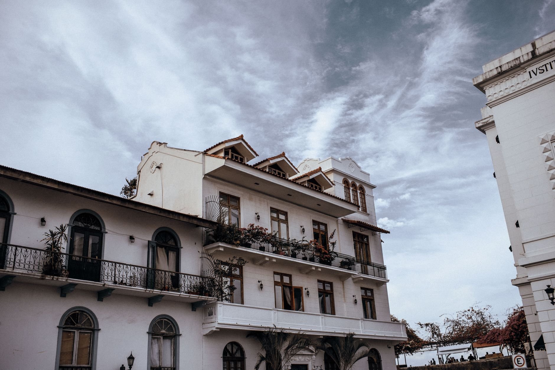 A weathered colonial-era building with wrought-iron balconies in a historic quarter.