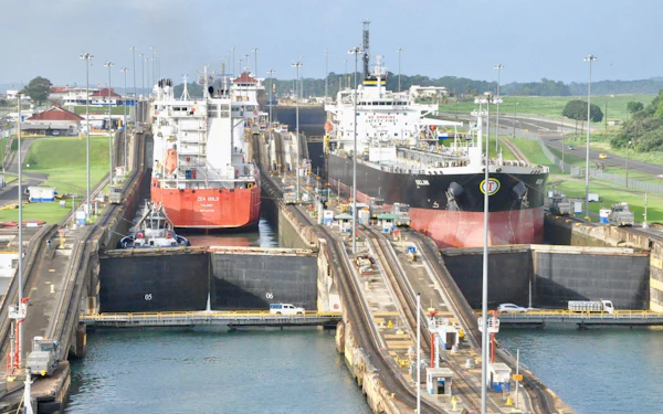 Container ships queued to transit a set of canal locks.
