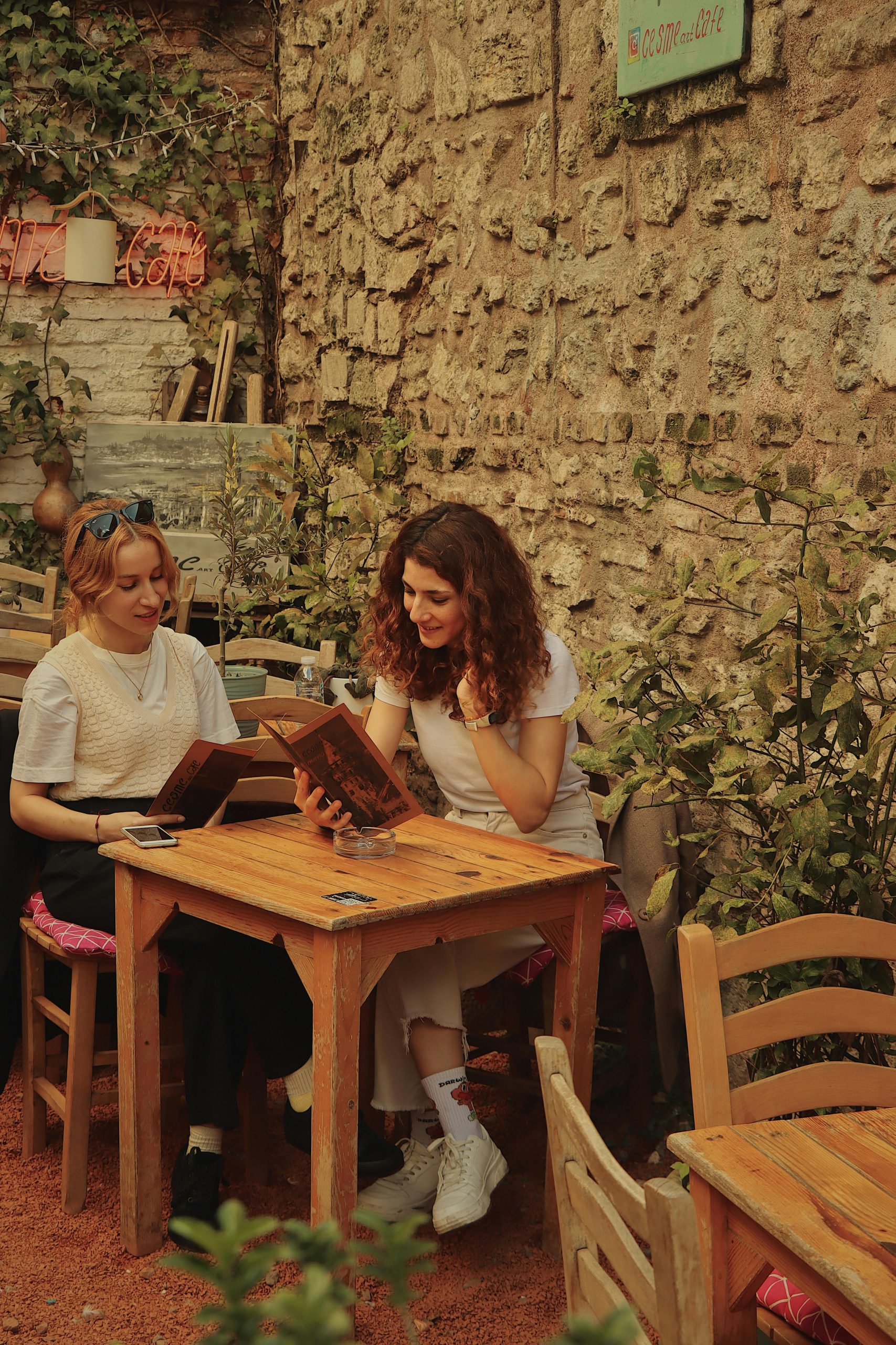 two girls dining in italy reading the menu