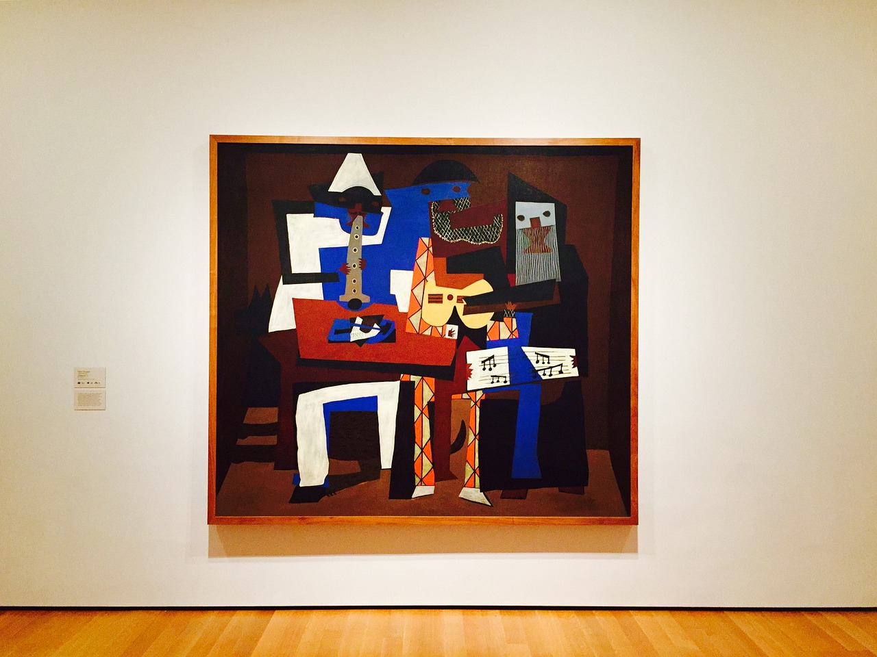 A cubist painting by Picasso displayed on a gallery wall