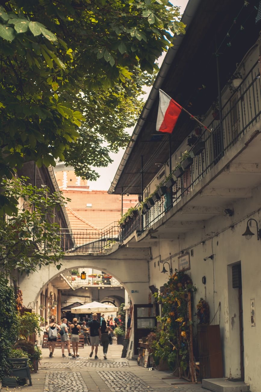 A narrow, colorful alleyway between old townhouses.