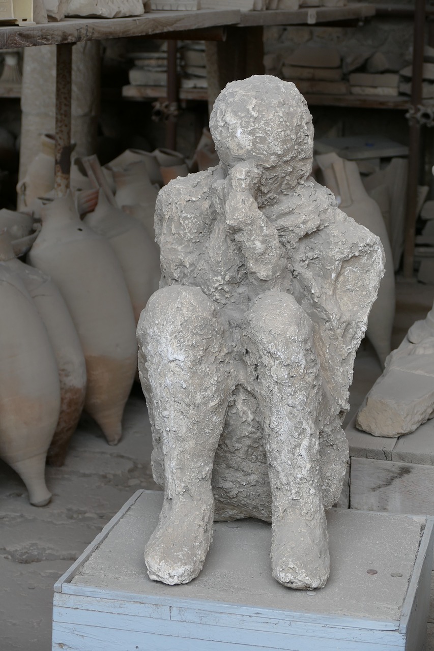 A plaster cast of a Pompeii victim displayed among ancient amphorae in a storage room