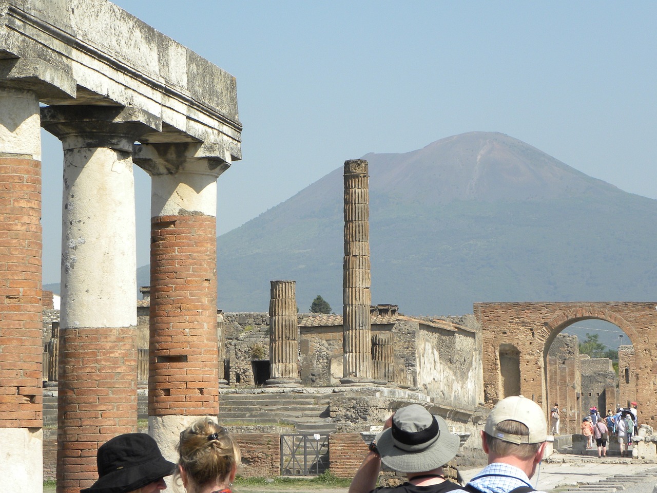 Students view Pompeii's ancient ruins with Mount Vesuvius rising in the background