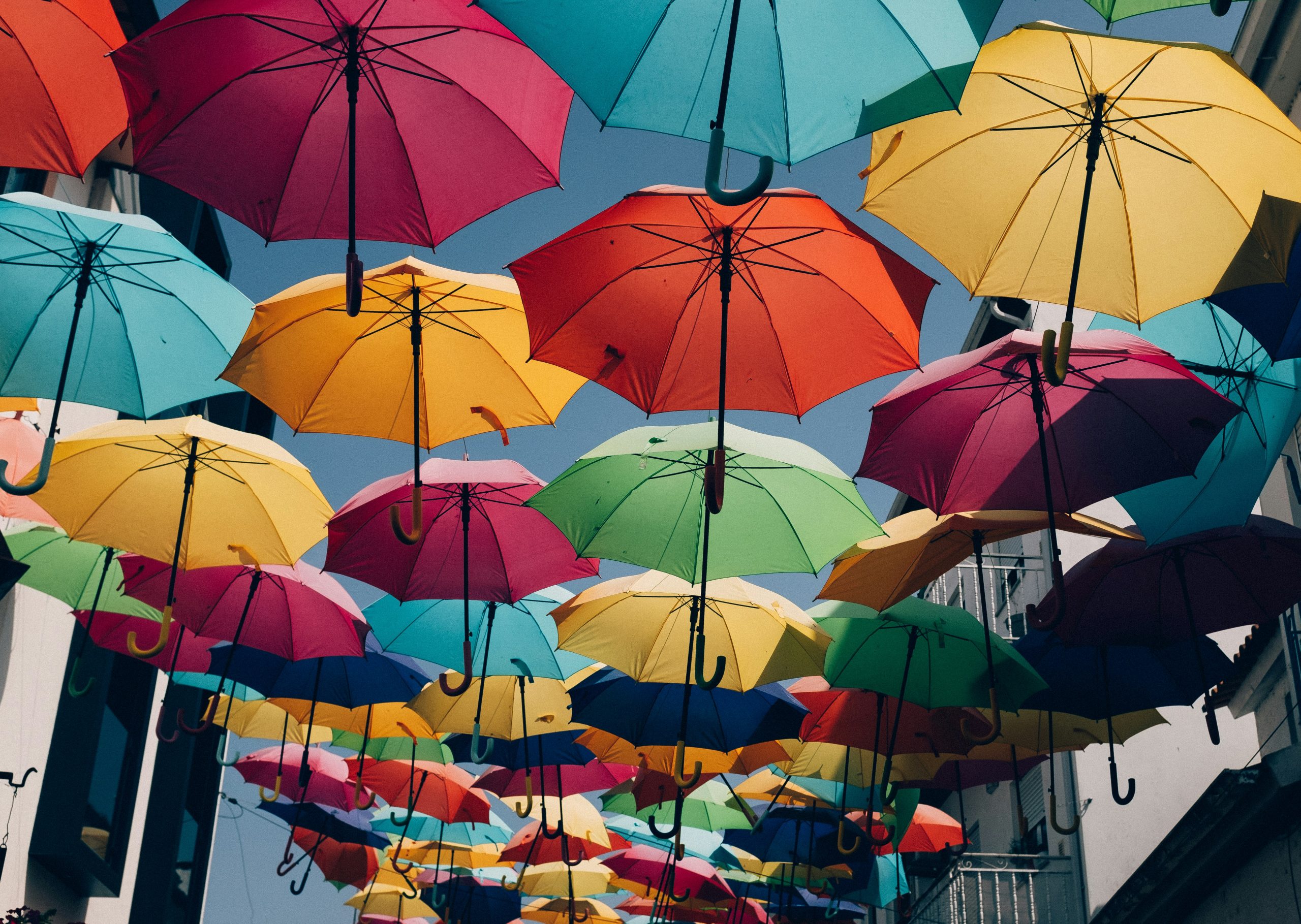 Colorful umbrella hanging in the sky.