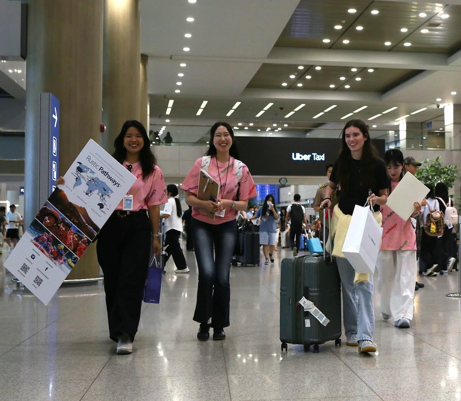 Rustic Pathways staff walk arriving students through the arrivals hall at Incheon International Airport in South Korea