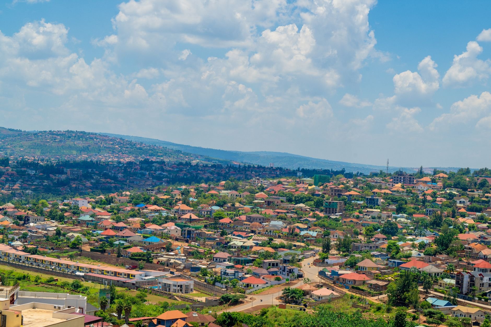 City rooftops spreading across green hills.