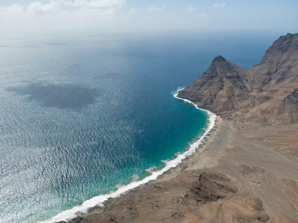 Shoreline of São Vicente Island in Cape Verde with rocky coast and blue waters.